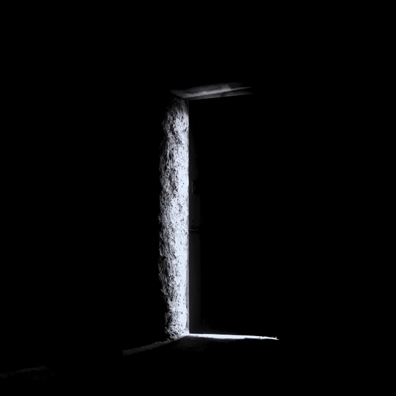 A quiet, stark moment illustrating painting dark before light